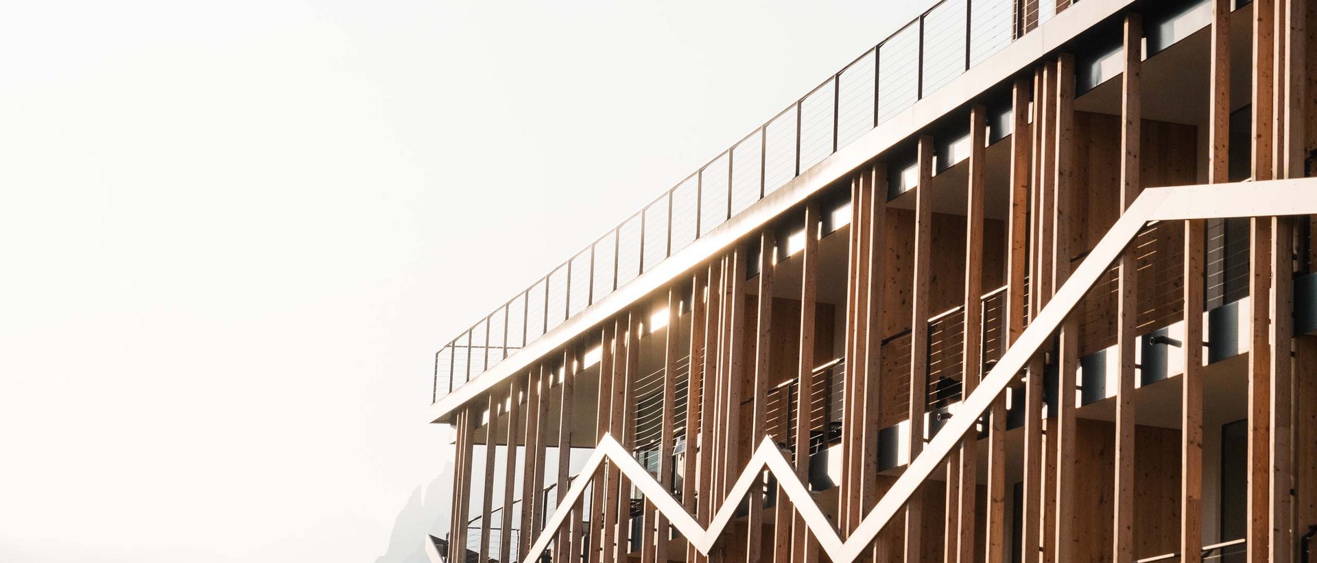 Dolomites Lodge Modern wooden building with white zigzag graphic pattern on the facade